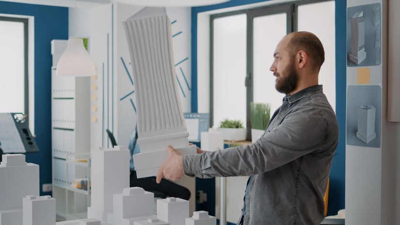 Man architect analyzing building model maquette design urban property architectural worker designing bleuprints plan construction layout modern structure project 482257 38834