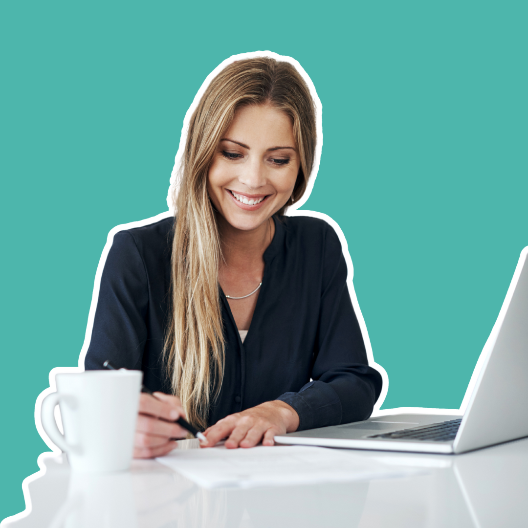 Woman at a desk with a pen and laptop, smiling softly in front of a light teal background.
