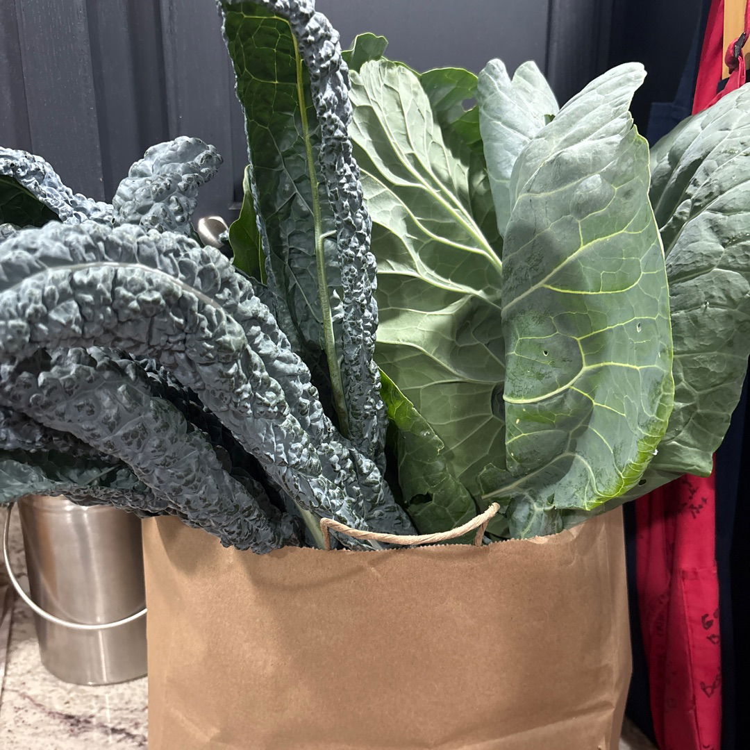 kale in a paper bag for donation