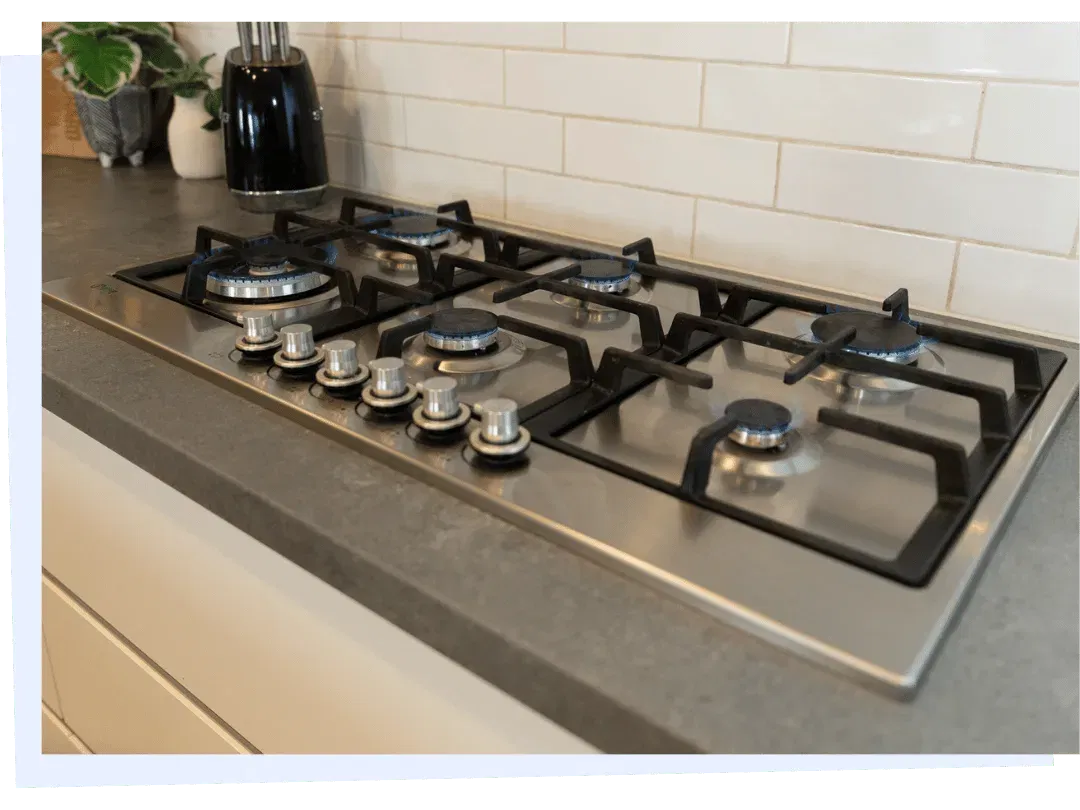 Gas cooktop installation with multiple burners in modern kitchen