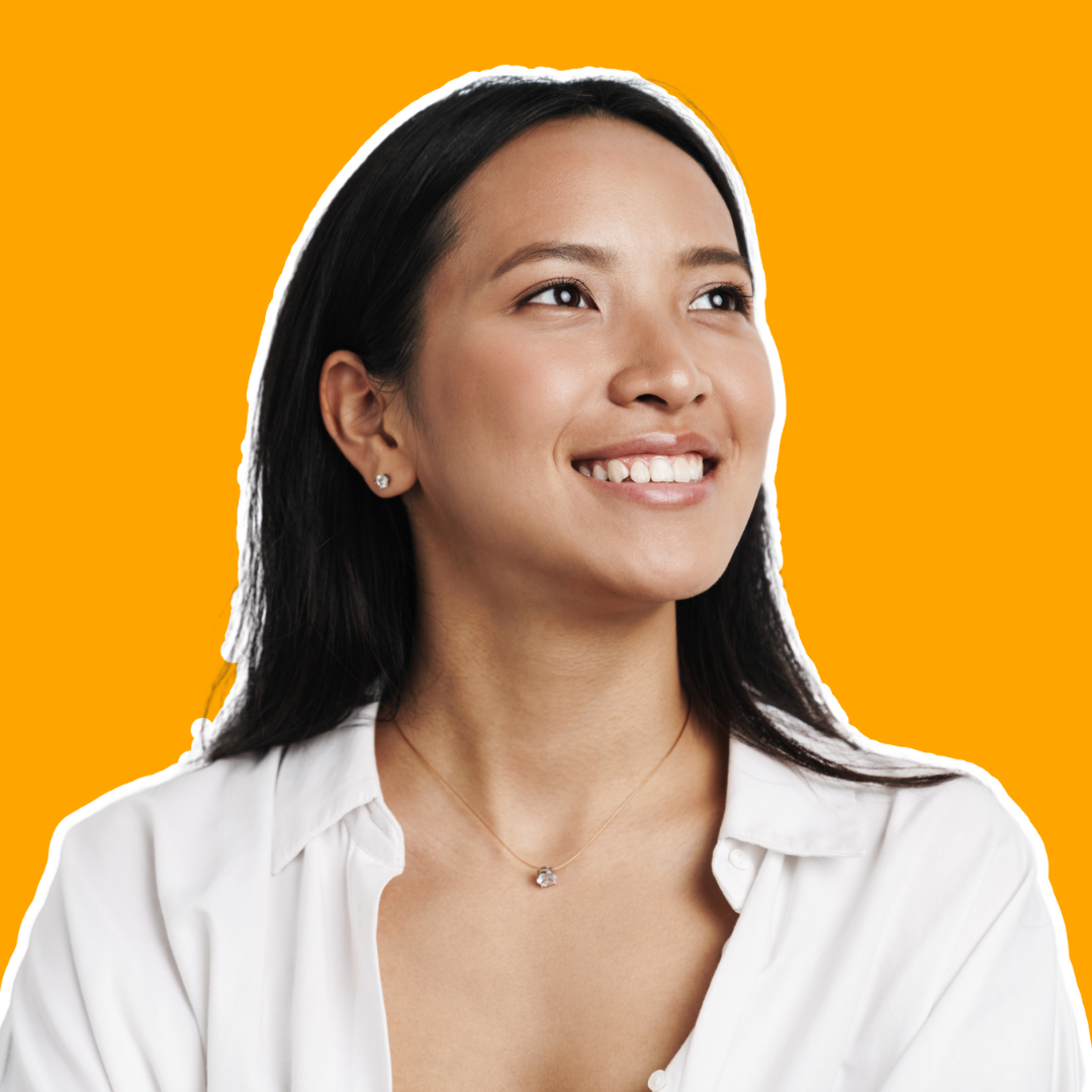 Confident woman looking upwards with a gentle smile, in front of a bright orange background.
