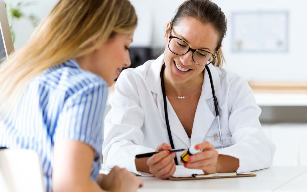 Friendly CIRS doctor consulting with a patient in a bright, healthy clinic — symbolizing compassionate care and recovery from mold illness.