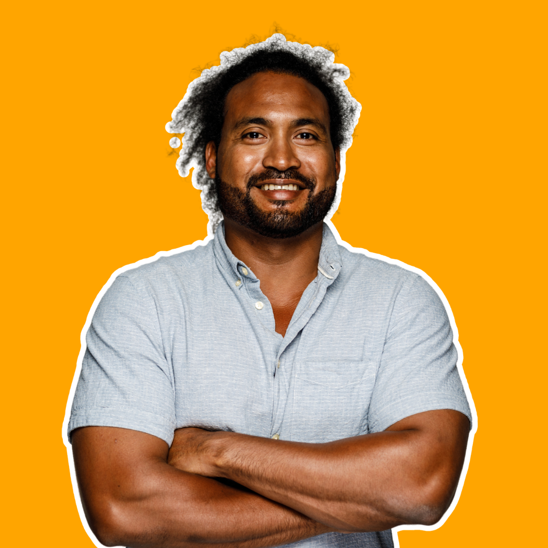 Smiling man with crossed arms in a grey shirt, standing confidently against a bright orange background.