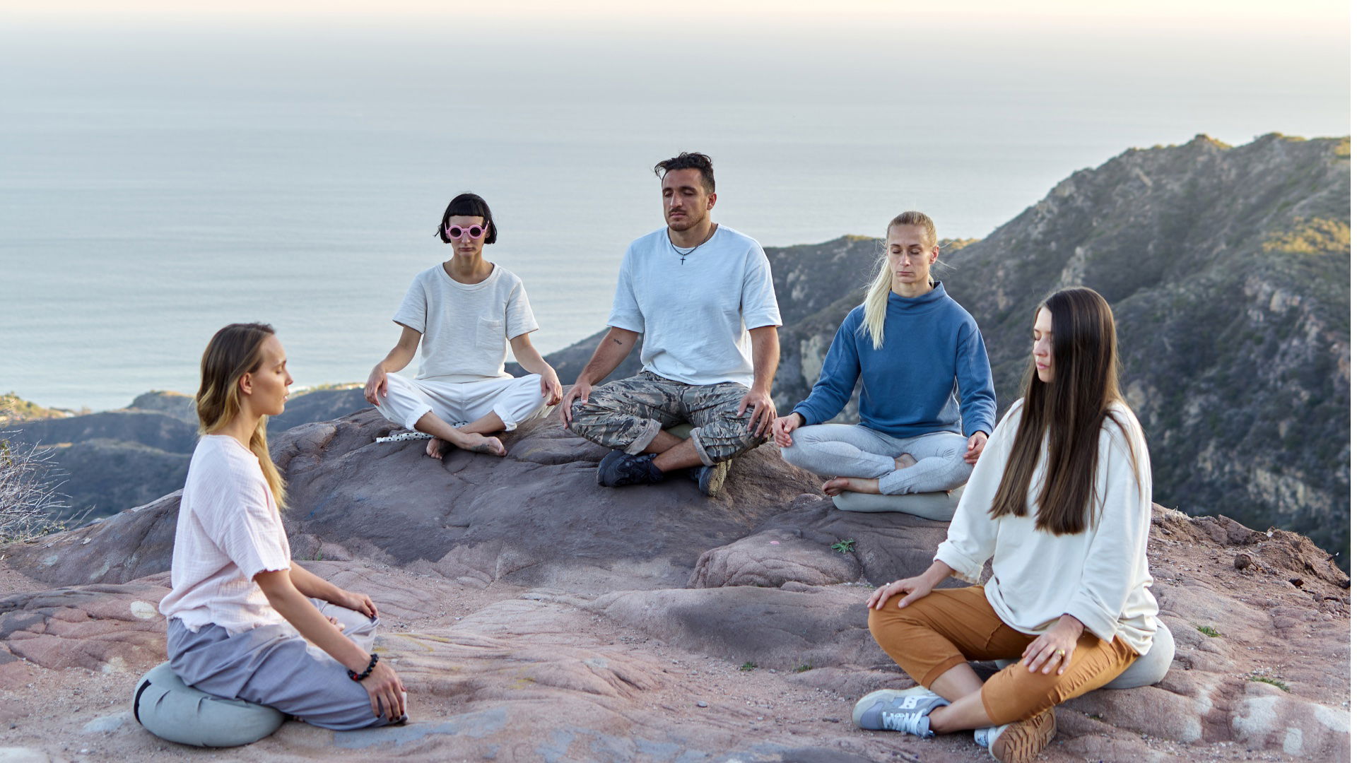 Yoga retreat participants practicing together in a calm outdoor setting.